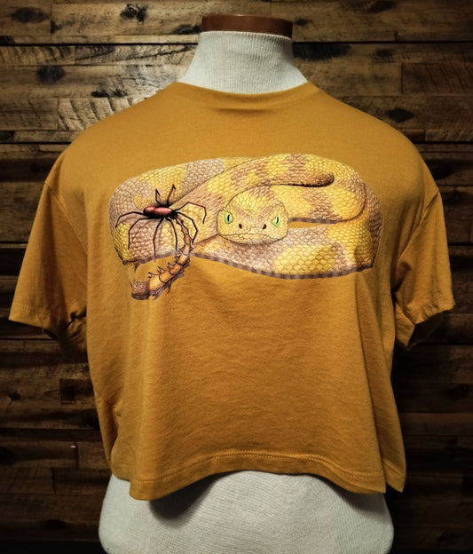 Yellow t-shirt with snake design on a wooden background