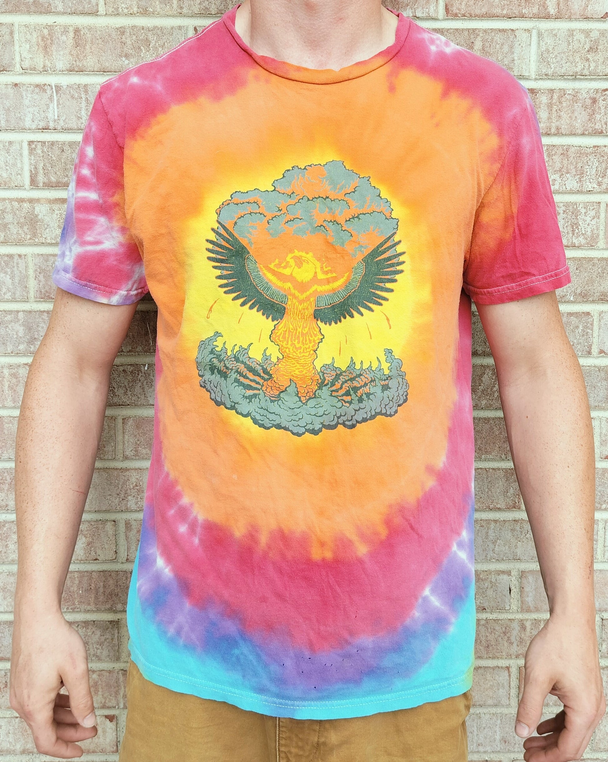 Phoenix rising from Atom bomb on Tie Dye shirt worn with brick background