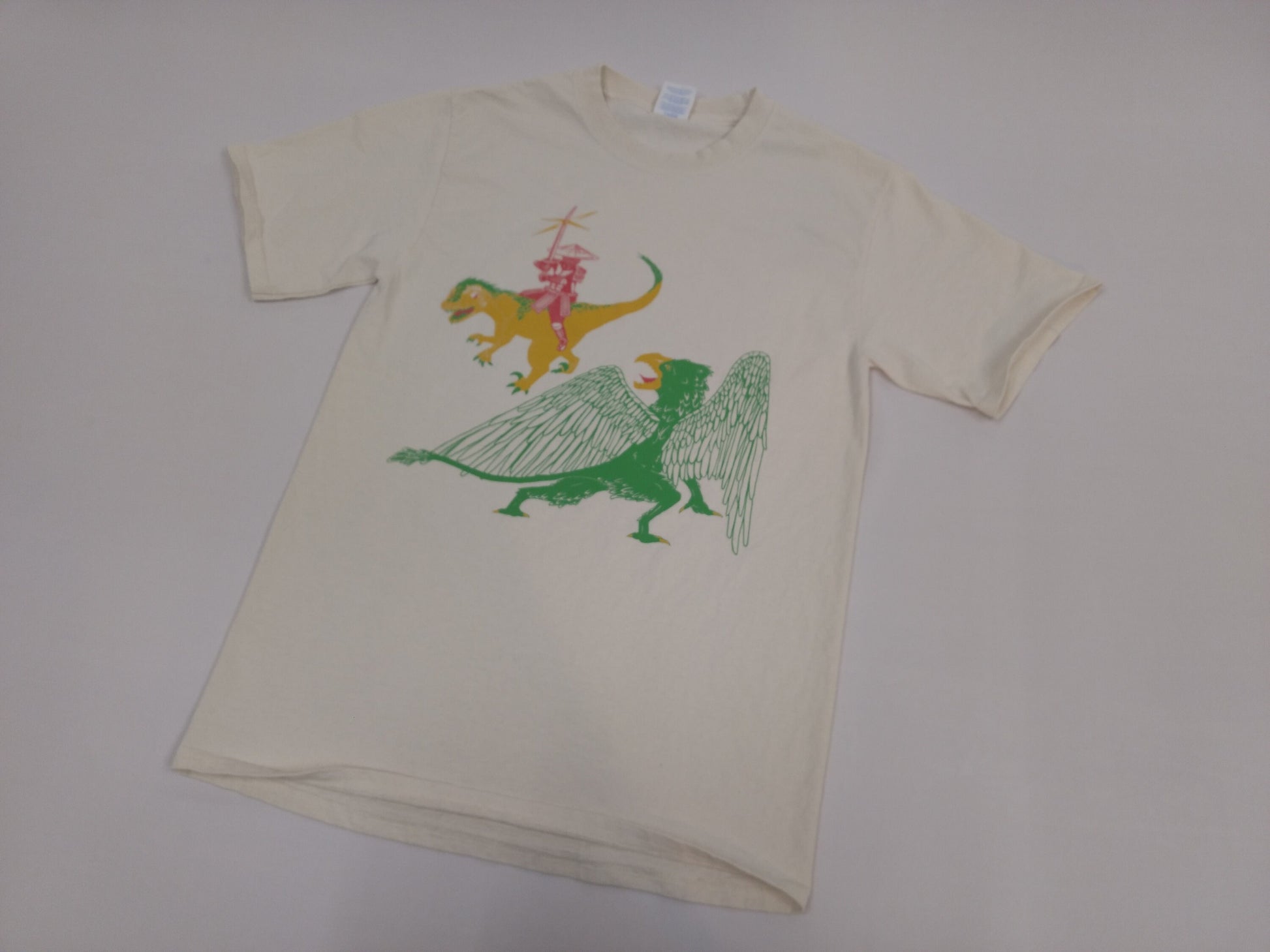 a white shirt with an illustration of a samurai, raptor, and griffon over a white background 
